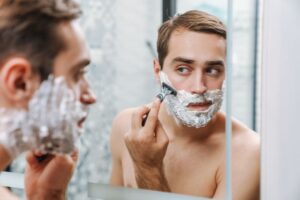 A man trimming his beard