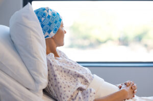 A cancer patient resting with a balding head due to a radiation therapy to the head