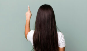 A woman standing and considering her preferred hair length