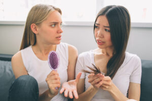 Two women discussing about balding due to family history (hereditary)