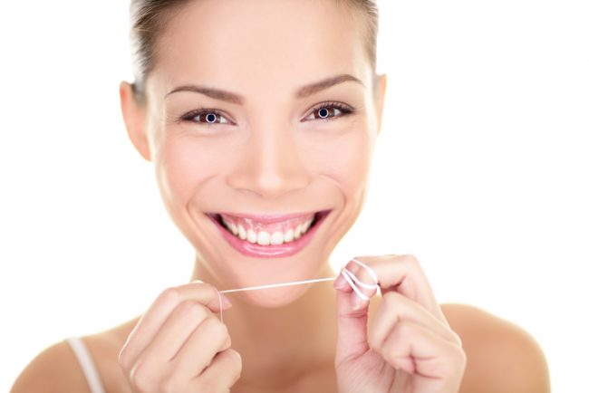 woman flossing e1475254608915