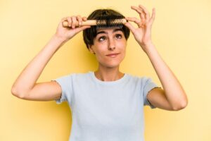 A woman brushing her bangs