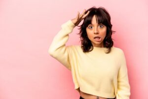 A woman touching her bangs