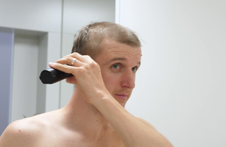 Young Man Cutting His Own Hair